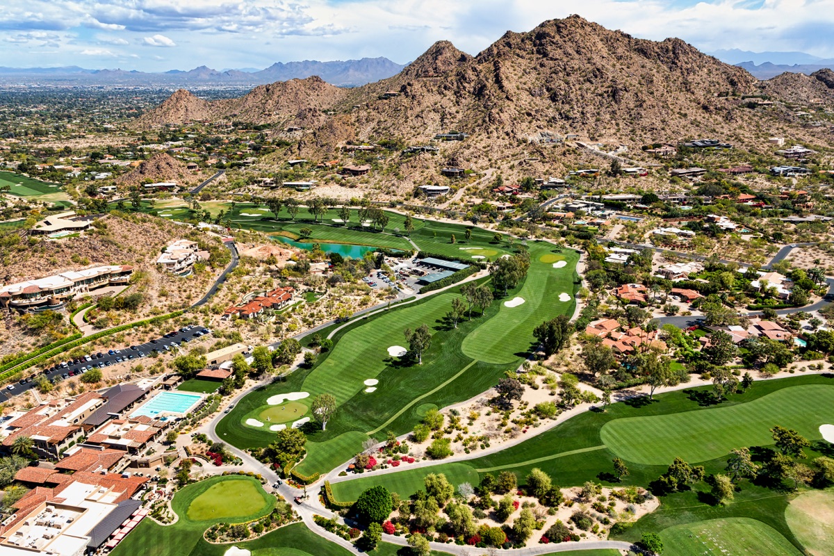Aerial view of a desert mountain neighborhood and golf course