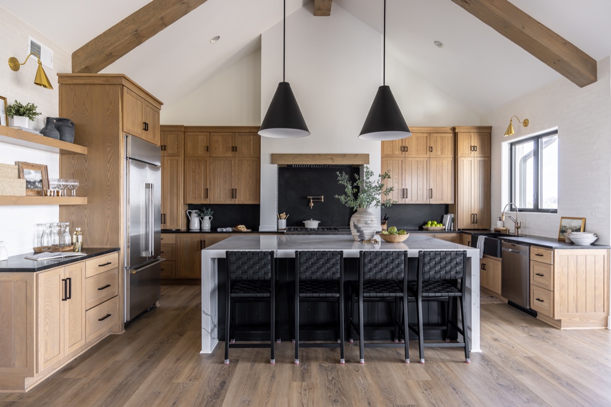 Oak kitchen with exposed beams and black pendant lights